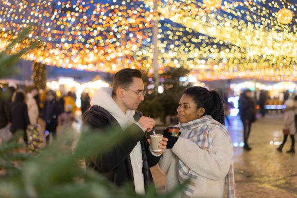 istock Couple sharing desert  on Christmas market 1365112290