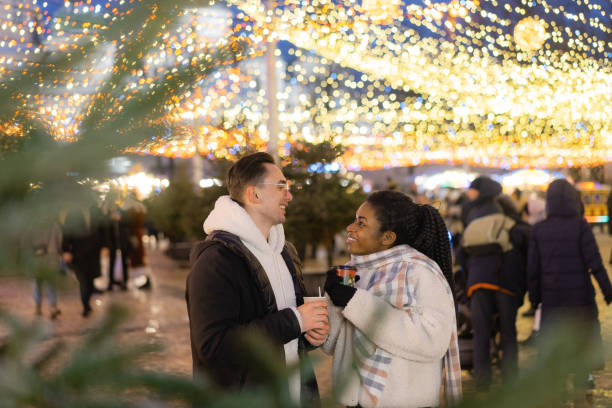 istock Couple sharing desert  on Christmas market 1365112319