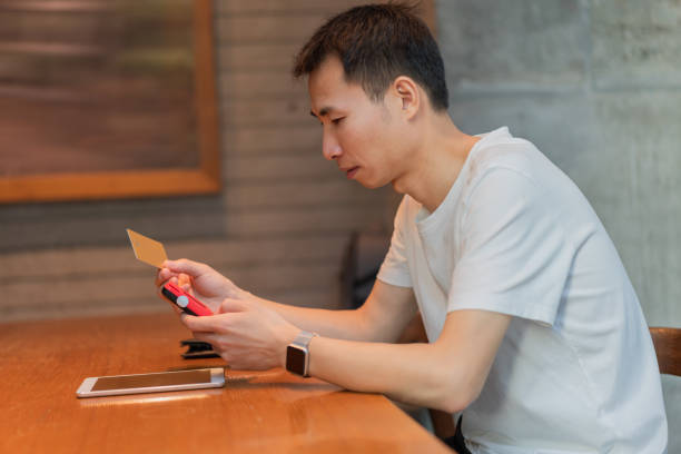 istock Asian man is paying with credit card 1365112812