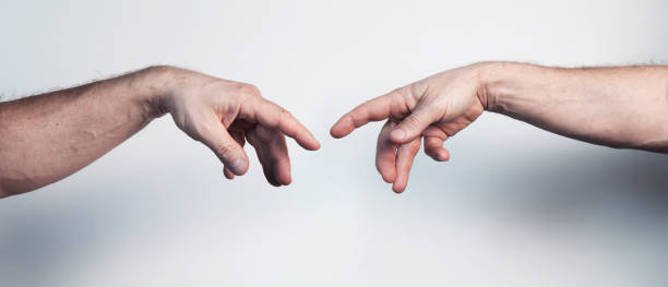 istock Two male hands posing like Da Vinci Creation of Adam masterpiece 1365115266