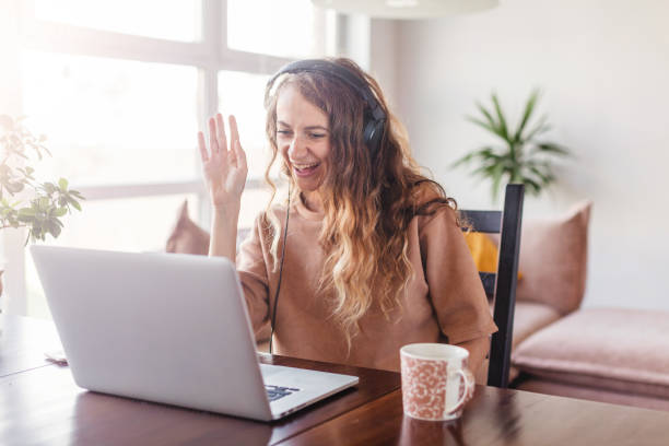 istock Woman in headphones communicates by video call 1365117166