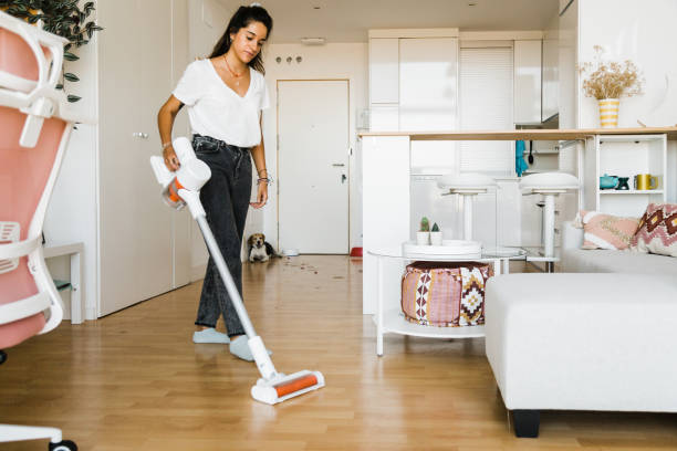 istock young woman vacuuming her home 1365119767