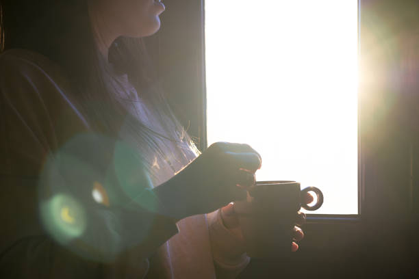 istock unrecognizable woman having a cup of coffee 1365121190