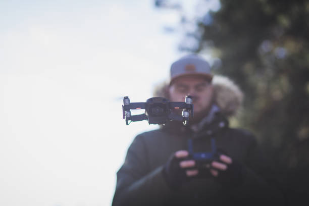 istock Young man piloting drone outdoor 1365121252