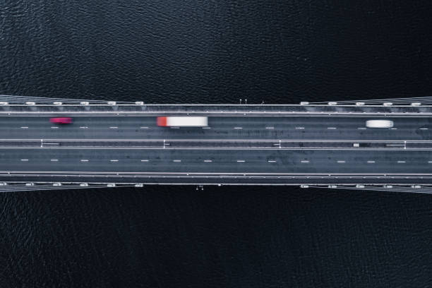 istock Vehicles Driving Across a Bridge Over Water 1365121374