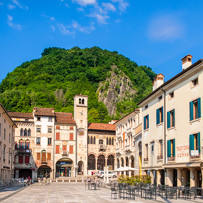 People sitting at the outdoor tables in Flaminio Square in Serravalle, the historic neighborhood of Vittorio Veneto