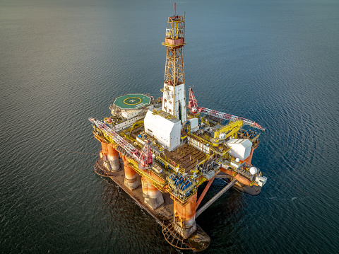 A drilling rig and platform used in the oil and gas industry for offshore fuel exploration