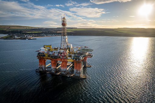 A drilling rig and platform used in the oil and gas industry for offshore fuel exploration