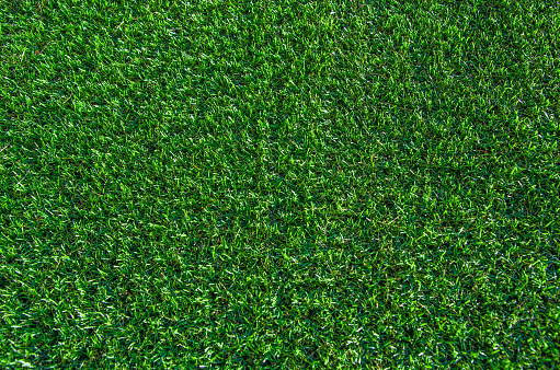 Green grass background. Lawn, football field, green grass artificial turf, texture, top view. summer lawn background