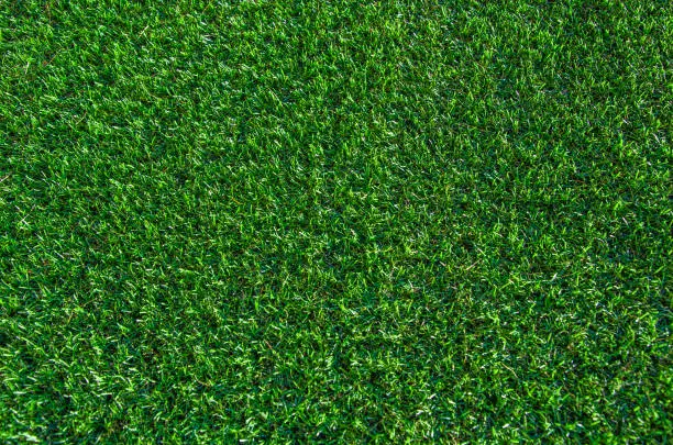 Photo of Green grass background. Lawn, football field, green grass artificial turf, texture, top view