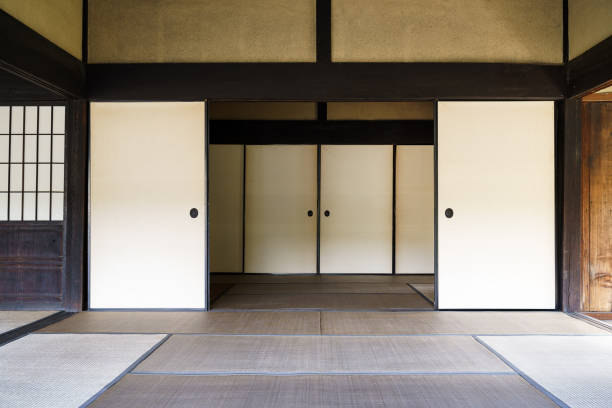 Two Japanese women contemplating the garden from the veranda in a traditional house.