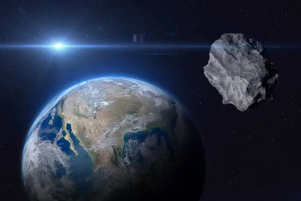 Photo of Planet Earth and asteroid.