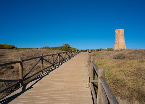 Marbella Cabopino Artola Dunes with Ladrones tower in natural park with Senda Litoral footpath walkway in Costa del Sol of Malaga in Andalusia Spain