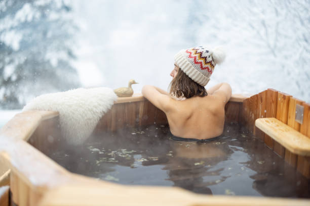 istock Woman relaxing in hot bath at snowy mountains 1365126099