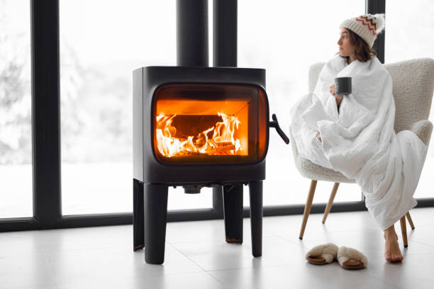 istock Woman at home with burning fireplace during wintertime on nature 1365127672