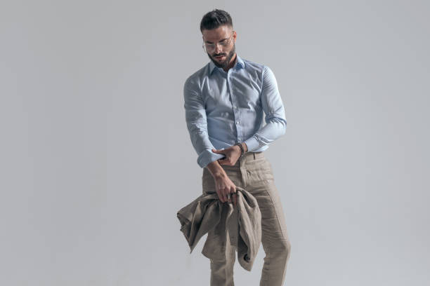 istock cool fashion model adjusting sleeve and holding jacket 1365128772
