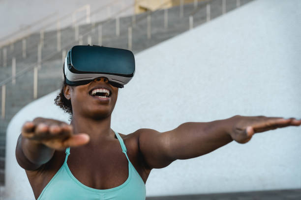 istock Happy fit African woman using virtual reality headset during training session - Technology and Innovated workout concept 1365130710