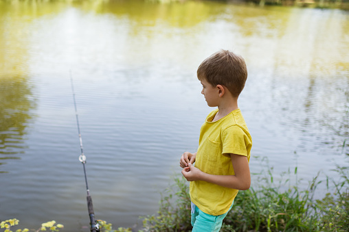 One boy fishing at the river.