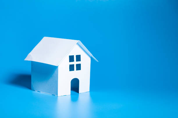 istock Toy house on a blue background. 1365133443
