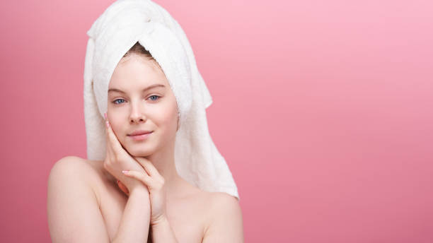 Close-up shot of young woman on pink background. stock photo