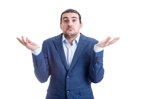 istock Clueless and perplexed businessman shrugging shoulders, hands outstretched, has doubts. Puzzled business person spreads his arms expressing uncertainty isolated on white background 1365134654