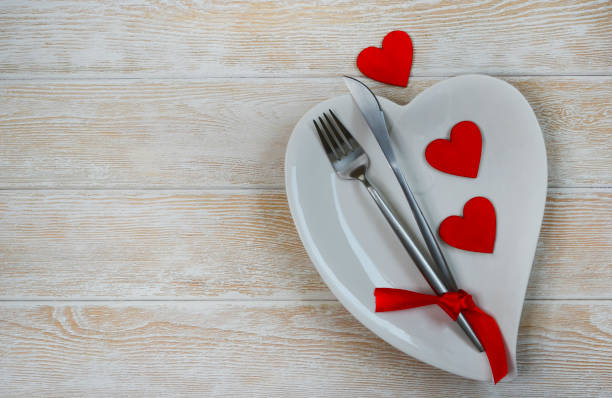istock valentines day table setting flat lay with love white ceramic plate shape heart, festive decoration, fork and knife 1365134845