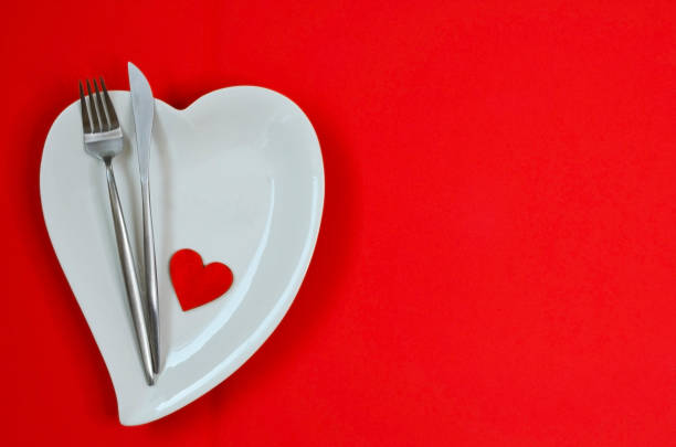 istock valentines day table setting flat lay with love white ceramic plate shape heart, festive decoration, fork and knife 1365134855
