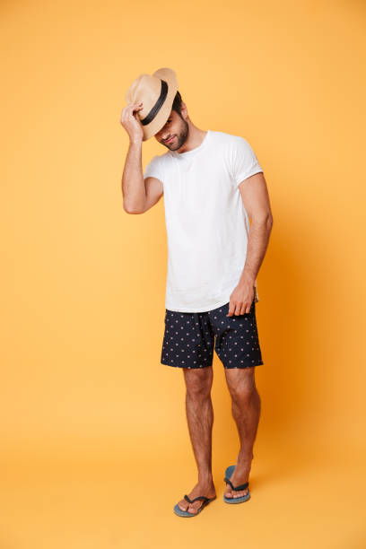 istock Young man wearing hat standing isolated 1365135075