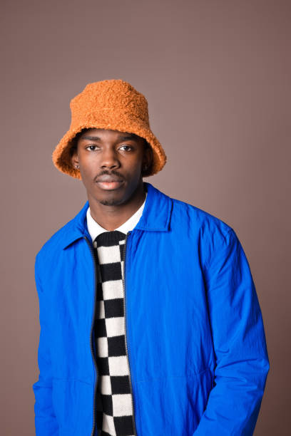 istock Confident young man against brown background 1365135204
