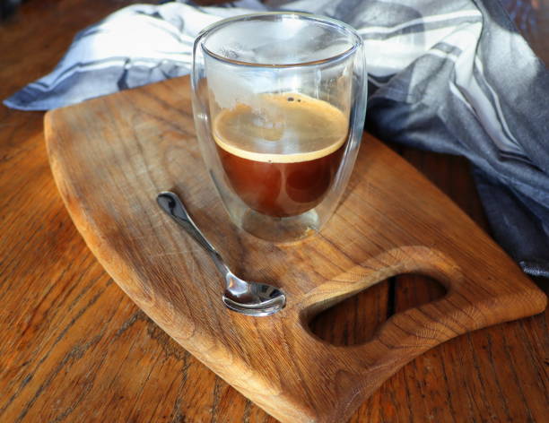istock Transparent double wall glass mug with espresso coffee on rustic wooden background . 1365135225