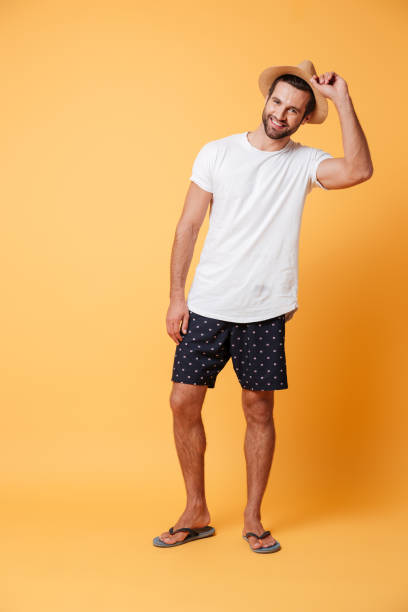 istock Bearded man looking camera and holding his hat 1365135244