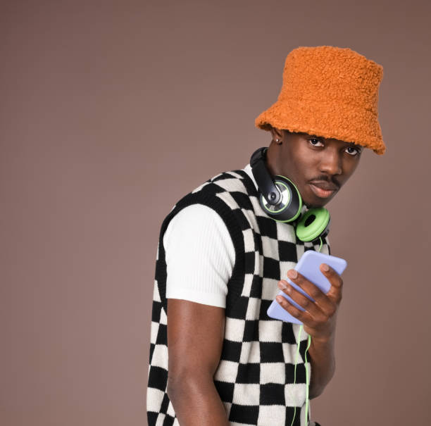 Confident young man against brown background