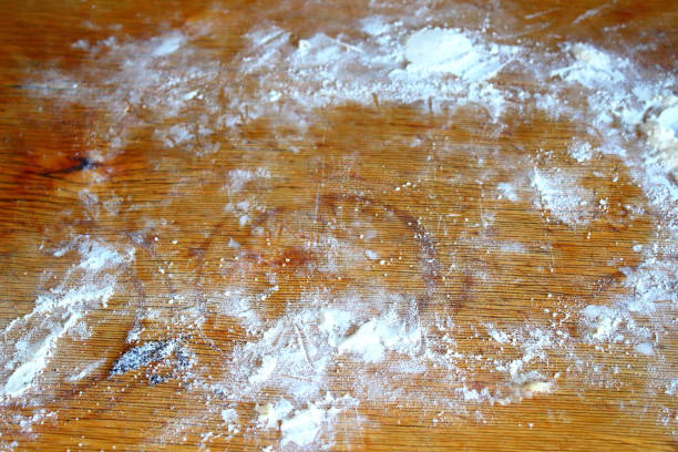 istock Flour on a wooden kitchen board. Background. Texture. 1365135503