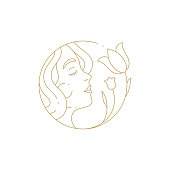 istock Linear simple logo female face smelling tulip at hand drawn circle frame for beauty spa salon vector 1365135561