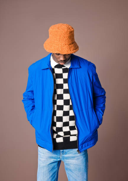 istock Confident young man against brown background 1365135697