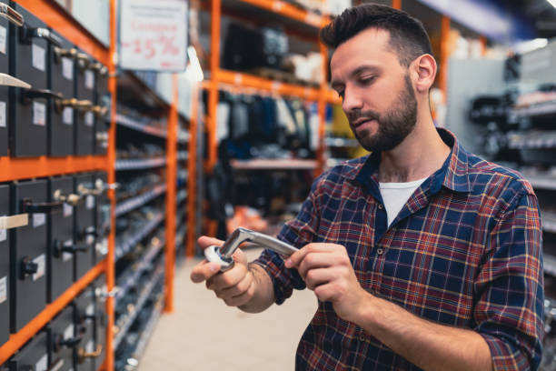 istock a man in a hardware store chooses a handle for a door 1365137261