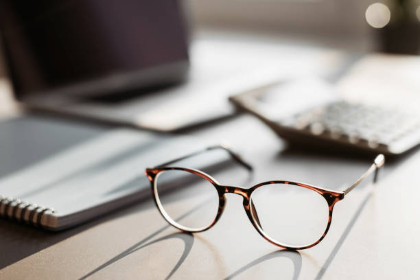 istock Work place in office, calculator, laptop computer, glasses at office desk 1365137299