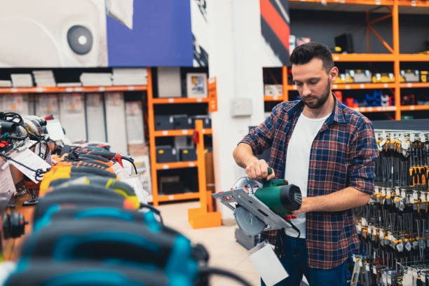 istock a builder in a power tool shop picks up a new circular saw. 1365137359