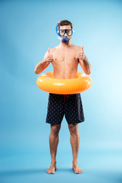 istock Young playful man showing thumbs up 1365137506