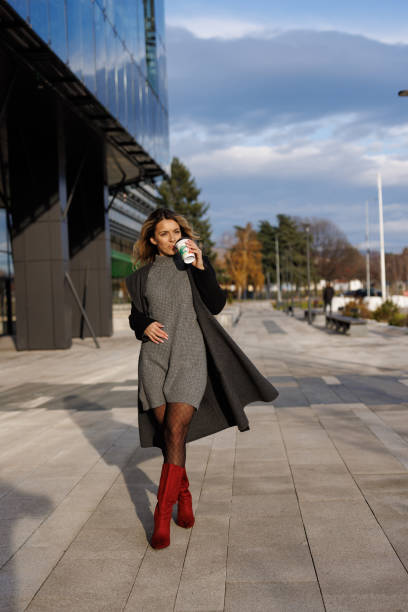 istock Businesswoman drinking coffee to go while commuting to work 1365137518