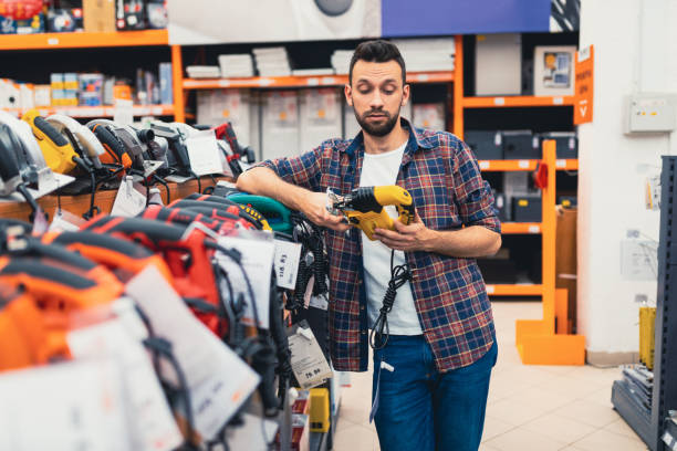 istock male customer chooses a woodworking jigsaw in a power tool store 1365137541
