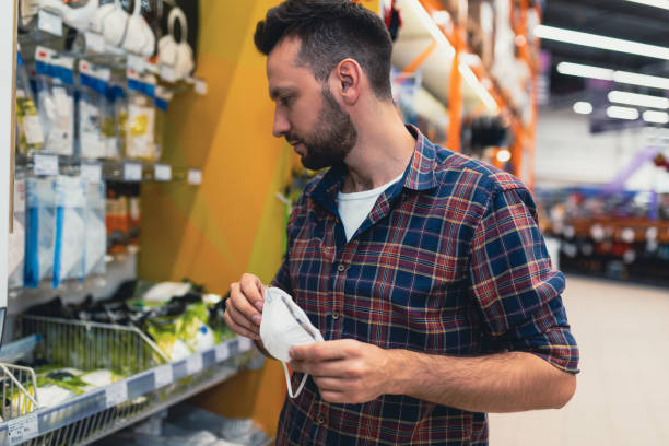 istock male customer in a hardware store chooses a mask for painting work 1365137597