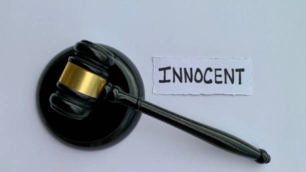 istock Innocent text on torn paper with judge gavel. Law concept 1365137656