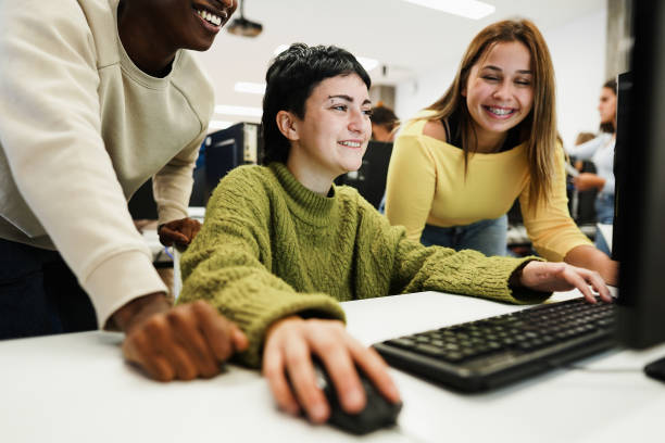 istock Young students using computers inside business class at school - Focus on center girl eye 1365137675