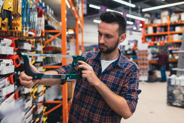 istock a customer in a hardware store chooses a hacksaw for metal 1365137690