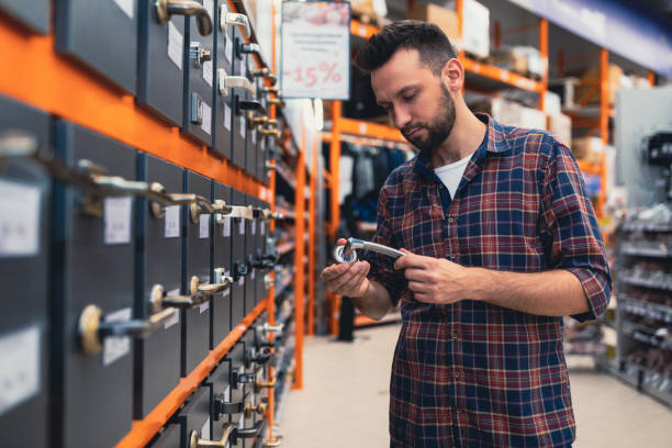 istock a man chooses a doorknob in a hardware store. 1365138280