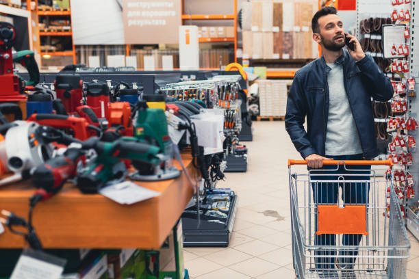 istock a buyer in a hardware store walks between the rows with a power tool. 1365138284