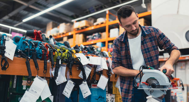 istock a man chooses a circular saw in a power tool store 1365138585