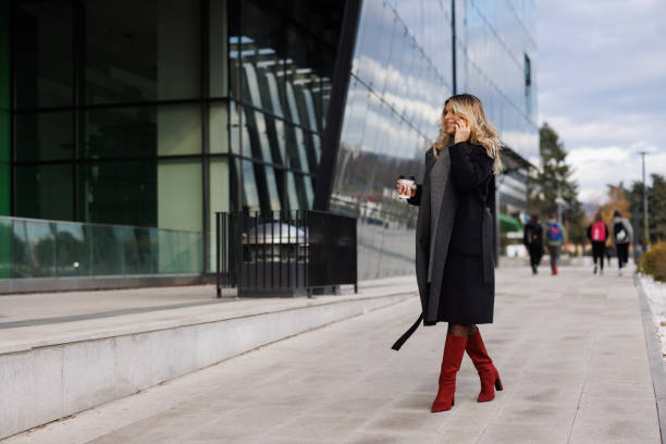 istock Business woman talking on phone while commuting to work 1365138619
