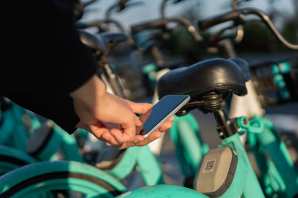 istock Asian man uses mobile phone to scan QR code to unlock shared bike 1365139059